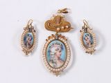 three pieces of jewelry including a picture of a woman and a bird