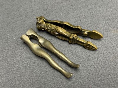 Deux casse-noisette en bronze: jambes de femme et chat