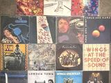 a lot of different album covers on the floor