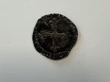 a close up of a coin on a table with a white background