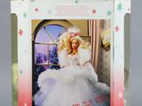 doll in a box with a picture of a woman dressed in a white dress