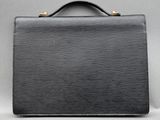 a black briefcase sitting on top of a gray surface