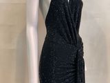 the mannequin is wearing a black dress with a tie around the waist
