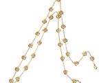 a gold plated necklace with coins and a chain on a white background