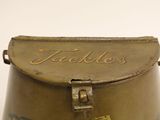 a small metal box with a handle and a name on it