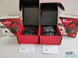 two boxes of headphones are open on a white surface