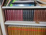 many books that are on the shelves in the room