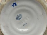 a close up of a white and blue bowl on a table