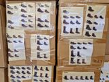 boxes of shoes are stacked on top of each other in a warehouse