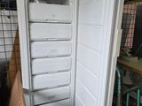 an open refrigerator that is sitting inside of a building