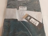 a shirt that is wrapped in plastic on a table
