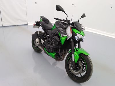 a picture of a green motorcycle parked in a garage