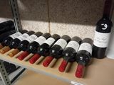 many bottles of wine sitting on a shelf in a store