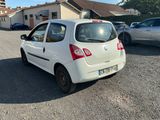 a small white car that is parked in a parking lot