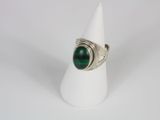 a close up of a ring with a green stone on it