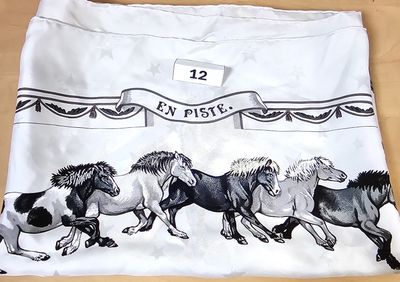 four horses running in a row on a white shirt