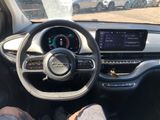 someone is sitting in the driver ' s seat of a car with their feet on the steering wheel