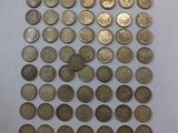 a pile of old coins sitting on top of a white surface