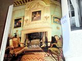 an open book with a picture of a living room in it