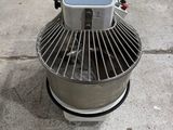 a machine that is sitting on the ground in a warehouse