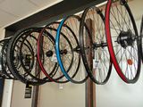a lot of bikes that are hanging on the wall