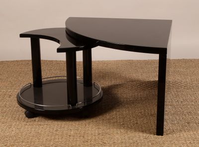 black glass coffee table with two curved legs and a glass shelf