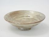 a white and brown bowl on a white surface