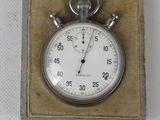 a silver pocket watch in a box on a white surface