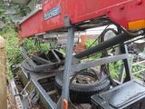 a red trailer that is parked next to a building