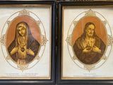 two framed pictures of a woman holding a baby and a man holding a child