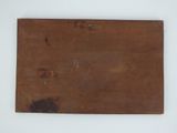 an old wooden sign on a white surface with a white background