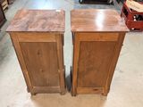 pair of wooden cabinets in a store with bottles of wine in the background