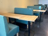 tables and chairs are lined up in a row in a restaurant