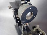 a close up of an old fashioned camera on a table