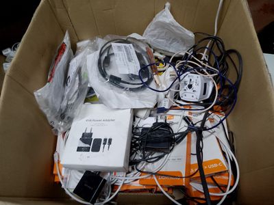 a cardboard box filled with electronic equipment and wires