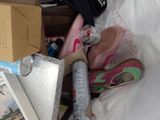 a pile of shoes and other items in a bag