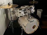 a drum set up in the corner of a room