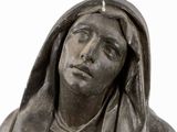 a statue of a woman with a hood over her head