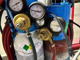 a close up of a gas cylinder with gauges and hoses