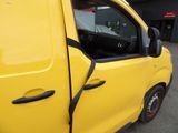 a small yellow van parked in front of a building