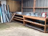 une étagère en bois sur laquelle sont posés des casseroles et des poêles, dans une remise