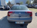 the back of a silver car parked in a parking lot