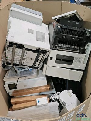 a cardboard box full of electronic equipment in a room