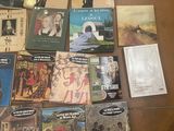 several books on a table with pictures of people and animals on them