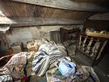 une chambre en désordre, avec beaucoup de bric-à-brac par terre