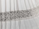 lace trimming on a white dress with a black and white background