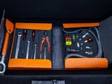 an orange case with tools in it sitting on a table