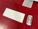 a computer monitor and a mouse on a red desk