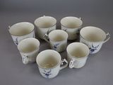 six cups that are arranged in a circle on the table