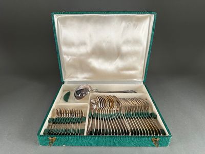a green case with silverware in it on a table